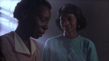 Movie still from “The Color Purple” (1985), directed by Steven Spielberg – Two people standing next to each other in the dark; Close Up shot, Low angle