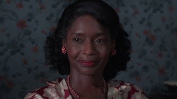 Movie still from “The Color Purple” (1985), directed by Steven Spielberg – A person wearing a necklace; Close Up shot, Low angle