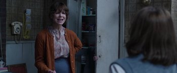 Movie still from “The Conjuring 2” (2016), directed by James Wan – A woman standing in front of an open door; Medium shot, Over the shoulder angle