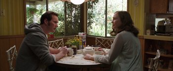 Movie still from “The Conjuring 2” (2016), directed by James Wan – A man and a woman are sitting at a table; Medium shot, Over the shoulder angle