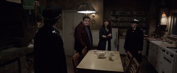 Movie still from “The Conjuring 2” (2016), directed by James Wan – A man and a woman standing at a dining room table; Medium shot, Over the shoulder angle