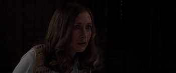 Movie still from “The Conjuring 2” (2016), directed by James Wan – A person with long brown hair; Close Up shot, Over the shoulder angle