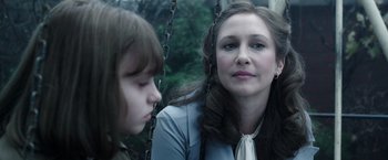 Movie still from “The Conjuring 2” (2016), directed by James Wan – A woman sitting next to a young girl on a swing; Close Up shot, Over the shoulder angle