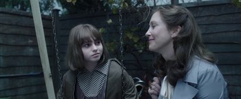Movie still from “The Conjuring 2” (2016), directed by James Wan – Two young women standing next to each other on a swing; Close Up shot, Over the shoulder angle