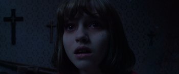 Movie still from “The Conjuring 2” (2016), directed by James Wan – A young woman with a tear in her eye; Close Up shot, High angle
