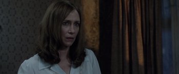 Movie still from “The Conjuring 2” (2016), directed by James Wan – A person wearing a white shirt; Close Up shot, Over the shoulder angle