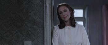 Movie still from “The Conjuring 2” (2016), directed by James Wan – A woman standing in a room next to a wall; Close Up shot, Over the shoulder angle
