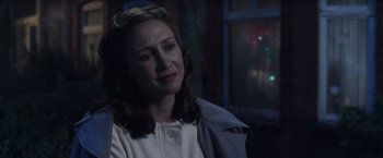 Movie still from “The Conjuring 2” (2016), directed by James Wan – A woman in a white shirt is looking sad; Close Up shot, Over the shoulder angle