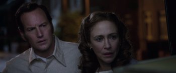 Movie still from “The Conjuring 2” (2016), directed by James Wan – A person sitting in front of another person; Close Up shot, Over the shoulder angle