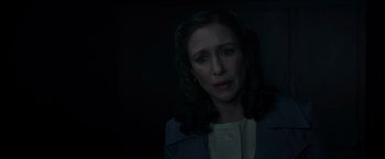 Movie still from “The Conjuring 2” (2016), directed by James Wan – A woman in a white shirt and a blue jacket; Close Up shot, Over the shoulder angle