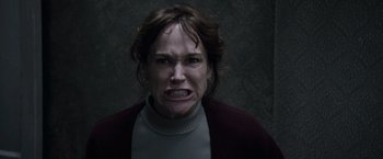 Movie still from “The Conjuring 2” (2016), directed by James Wan – A person making a funny face; Close Up shot, Low angle