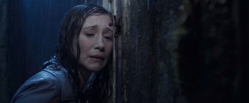 Movie still from “The Conjuring 2” (2016), directed by James Wan – A woman with her head hanging over a door; Close Up shot, High angle