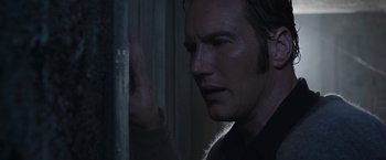 Movie still from “The Conjuring 2” (2016), directed by James Wan – A person looking at a wall; Close Up shot, Over the shoulder angle