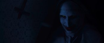 Movie still from “The Conjuring 2” (2016), directed by James Wan – A demonic looking demon with a glowing yellow eye; Close Up shot, High angle