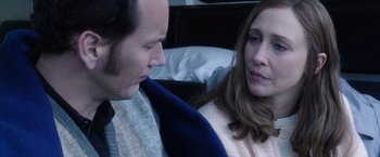 Movie still from “The Conjuring 2” (2016), directed by James Wan – A man and a woman sitting next to each other on a bed; Close Up shot, Over the shoulder angle
