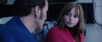 Movie still from “The Conjuring 2” (2016), directed by James Wan – A man and a woman sitting next to each other; Close Up shot, Over the shoulder angle