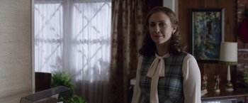 Movie still from “The Conjuring 2” (2016), directed by James Wan – A woman standing in front of a window with curtains; Medium shot, Over the shoulder angle