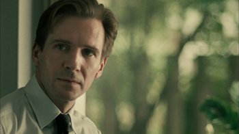 Movie still from “The Constant Gardener” (2005), directed by Fernando Meirelles – A person wearing a suit and tie; Close Up shot, Over the shoulder angle