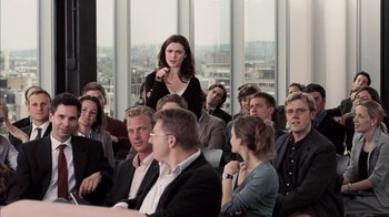 Movie still from “The Constant Gardener” (2005), directed by Fernando Meirelles – A group of people sitting in front of a window; Medium shot, Over the shoulder angle