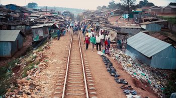 Movie still from “The Constant Gardener” (2005), directed by Fernando Meirelles – A group of people walking down a train track; Extreme Wide shot, High angle