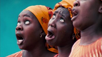Movie still from “The Constant Gardener” (2005), directed by Fernando Meirelles – A group of women singing in a group; Close Up shot, Low angle