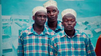 Movie still from “The Constant Gardener” (2005), directed by Fernando Meirelles – A group of men standing next to each other; Medium shot, Low angle