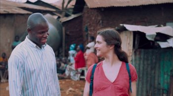 Movie still from “The Constant Gardener” (2005), directed by Fernando Meirelles – A man and a woman are talking in front of some houses; Medium shot, Over the shoulder angle