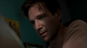 Movie still from “The Constant Gardener” (2005), directed by Fernando Meirelles – A person looking at a mirror; Close Up shot, Low angle