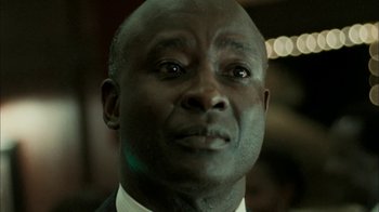 Movie still from “The Constant Gardener” (2005), directed by Fernando Meirelles – A person wearing a suit and tie; Close Up shot, Low angle