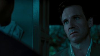 Movie still from “The Constant Gardener” (2005), directed by Fernando Meirelles – A person looking at something in a mirror; Close Up shot, Over the shoulder angle