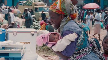 Movie still from “The Constant Gardener” (2005), directed by Fernando Meirelles – A woman holding a baby in her arms; Medium shot, Over the shoulder angle