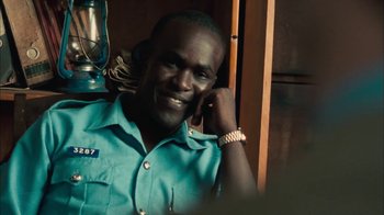 Movie still from “The Constant Gardener” (2005), directed by Fernando Meirelles – A man in a blue shirt talking on a phone; Close Up shot, Low angle