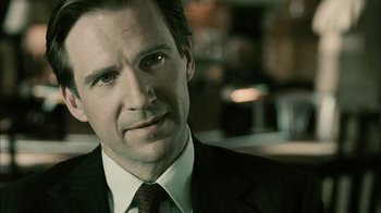 Movie still from “The Constant Gardener” (2005), directed by Fernando Meirelles – A person wearing a suit and tie; Close Up shot, Over the shoulder angle