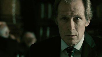 Movie still from “The Constant Gardener” (2005), directed by Fernando Meirelles – A person wearing a suit and tie; Close Up shot, Low angle