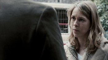 Movie still from “The Constant Gardener” (2005), directed by Fernando Meirelles – A woman sitting in front of another person; Close Up shot, Over the shoulder angle