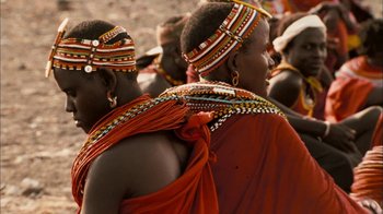 Movie still from “The Constant Gardener” (2005), directed by Fernando Meirelles – A group of people wearing traditional clothing; Close Up shot, Over the shoulder angle
