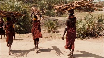 Movie still from “The Constant Gardener” (2005), directed by Fernando Meirelles – A couple of people walking on a dirt road; Wide shot, Over the shoulder angle