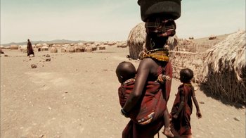 Movie still from “The Constant Gardener” (2005), directed by Fernando Meirelles – A woman carrying a child on her back; Wide shot, High angle