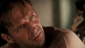 Movie still from “The Constant Gardener” (2005), directed by Fernando Meirelles – A man's face in a brown shirt; Close Up shot, Over the shoulder angle