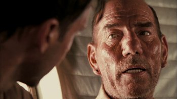 Movie still from “The Constant Gardener” (2005), directed by Fernando Meirelles – An older man looking at a younger man in front of a window; Close Up shot, Over the shoulder angle