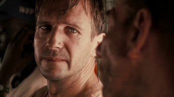 Movie still from “The Constant Gardener” (2005), directed by Fernando Meirelles – A person looking at the camera; Close Up shot, Over the shoulder angle