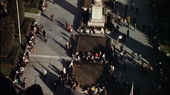 Movie still from “The Conversation” (1974), directed by Francis Ford Coppola – An aerial view of a crowd of people walking on the sidewalk; Extreme Wide shot, Overhead angle