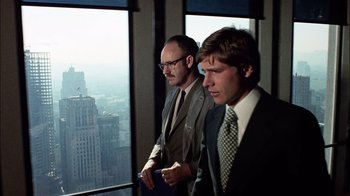 Movie still from “The Conversation” (1974), directed by Francis Ford Coppola – Two businessmen looking out of a skyscraper window; Medium shot, Low angle