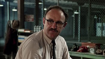 Movie still from “The Conversation” (1974), directed by Francis Ford Coppola – A man with a beard and mustache wearing a tie; Close Up shot, Low angle