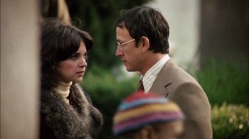 Movie still from “The Conversation” (1974), directed by Francis Ford Coppola – A man and a woman standing next to each other; Close Up shot, Over the shoulder angle