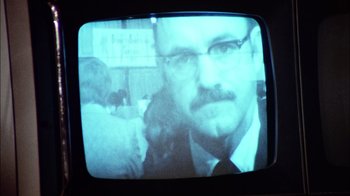 Movie still from “The Conversation” (1974), directed by Francis Ford Coppola – A person wearing a suit and tie; Extreme Close Up shot, Low angle