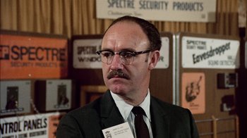 Movie still from “The Conversation” (1974), directed by Francis Ford Coppola – A man in a suit and tie wearing a tie; Close Up shot, Low angle