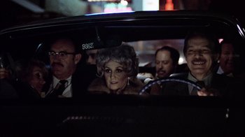 Movie still from “The Conversation” (1974), directed by Francis Ford Coppola – An old woman in a car with a bunch of people in the back seat; Close Up shot, Over the shoulder angle