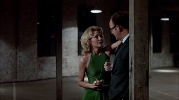 Movie still from “The Conversation” (1974), directed by Francis Ford Coppola – A man and a woman standing next to each other; Medium shot, Low angle