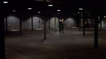 Movie still from “The Conversation” (1974), directed by Francis Ford Coppola – Two people dance in an empty room with lights on; Extreme Wide shot, High angle